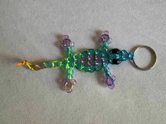 Clear blue and purple Kandi lizard